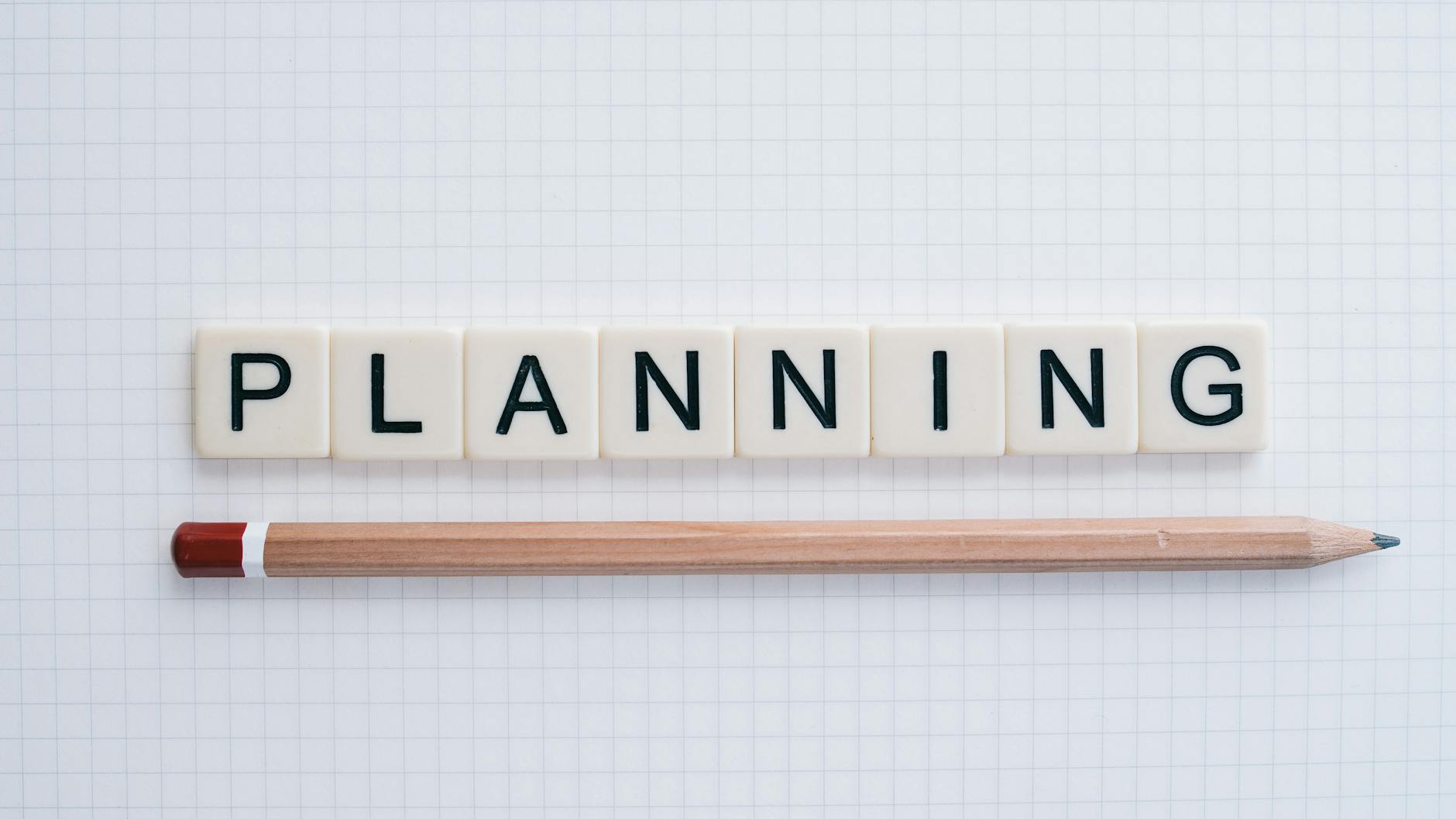 the word planning spelled in letter tiles